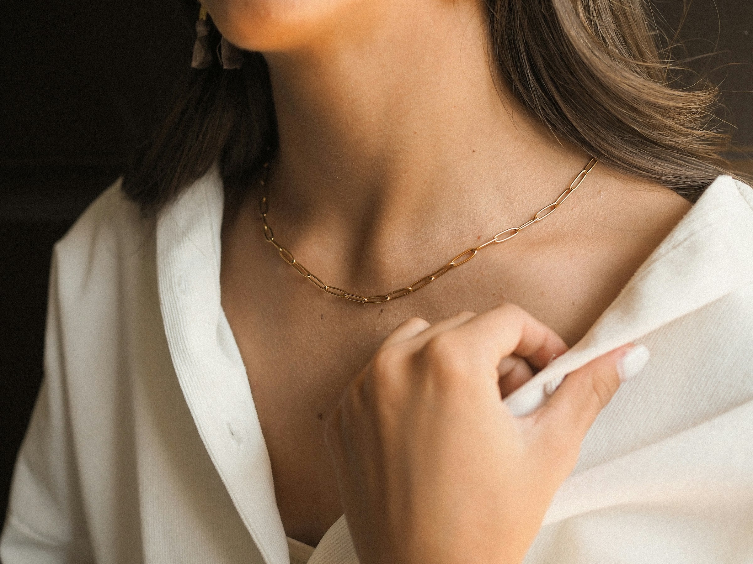 Woman wearing an elegant gold pendant necklace